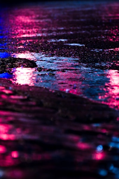 Pink and blue light reflected on the road
